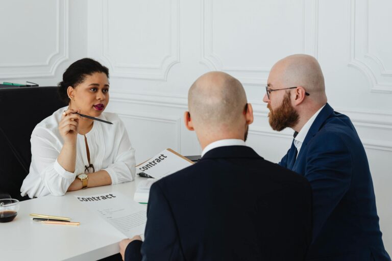 Business colleagues meeting in an office to discuss a contract negotiation.